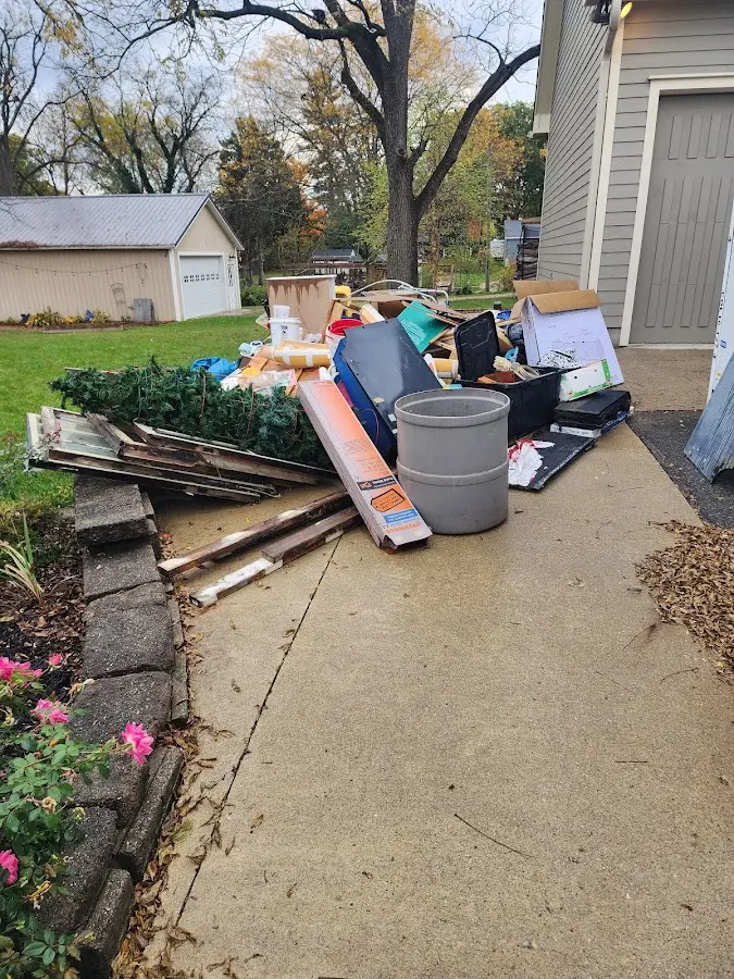 Dumpster being loaded with debris for Roofing Dumpster Rental in Villas